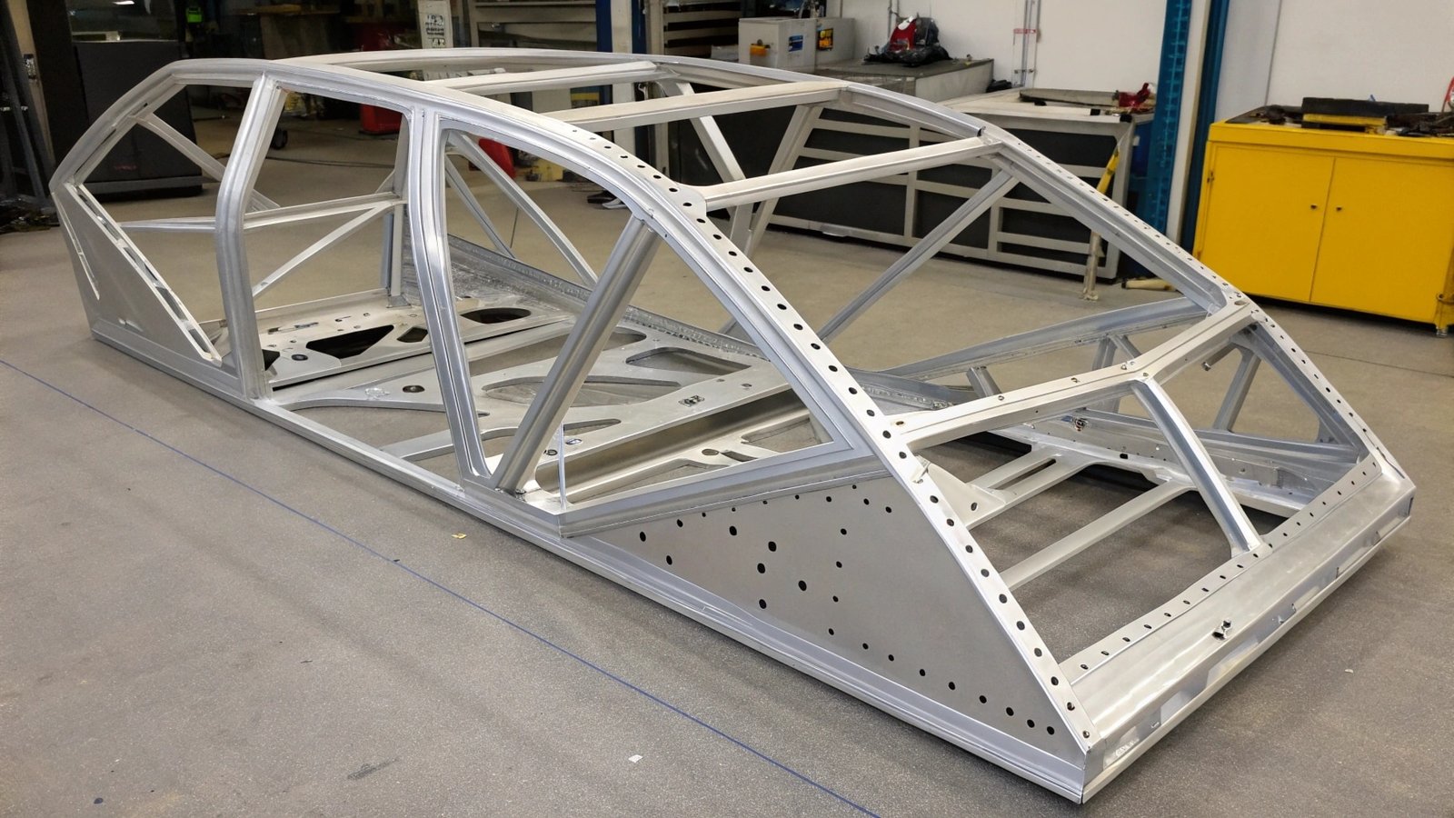 A close-up image showing a sharp tool easily scratching a soft 1100 aluminum sample, while it barely marks a hard 7075-T6 sample.